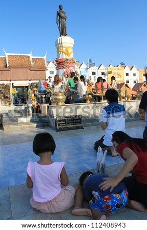 NAKHON RATCHASIMA, THAILAND-AUG 28:People brought their children to Suranaree monument to pray for blessings and better life on August 28, 2012 in Nakhon Ratchasima, Thailand.