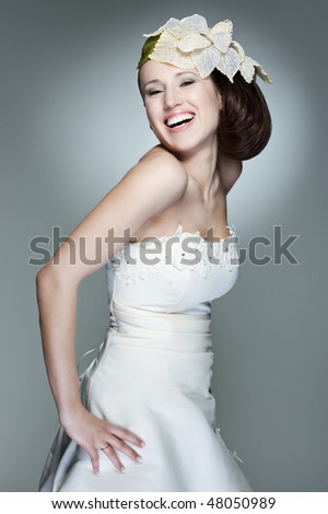 portrait of happy beautiful bride against grey background
