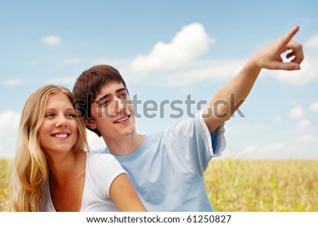 portrait of beautiful smiley couple over blue sky