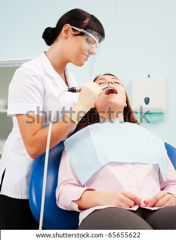 portrait of smiley dentist in mask and patient