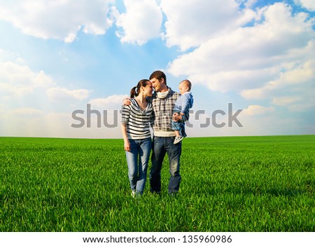 full-length portrait of happy and smiley family at outdoors