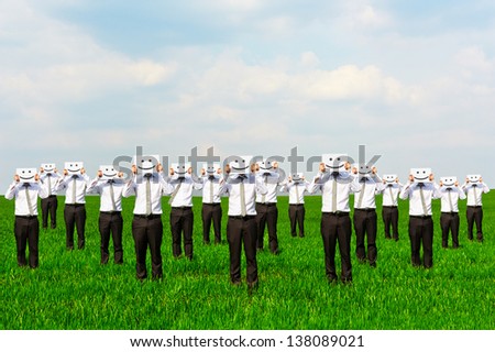 businessmen hiding their faces behind smile sing