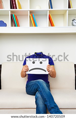 faceless man sitting on sofa and have a bad mood