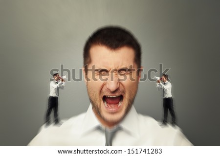 emotional man listening his inner voice over grey background
