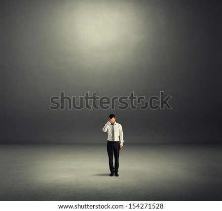 sad businessman in dark room