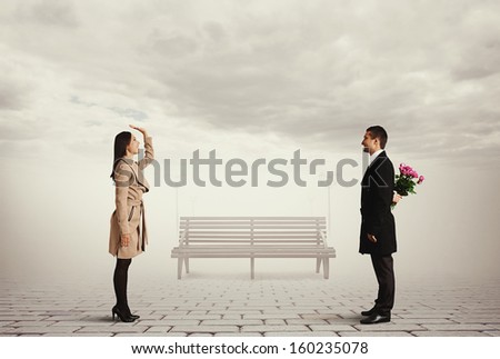 smiley beautiful woman greeting man with flowers