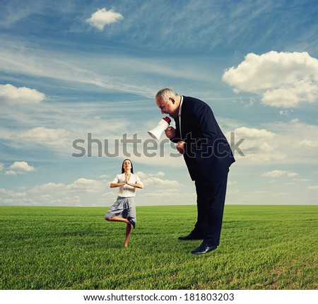 angry businessman screaming at calm small businesswoman