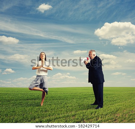 emotional man screaming at calm woman in the field