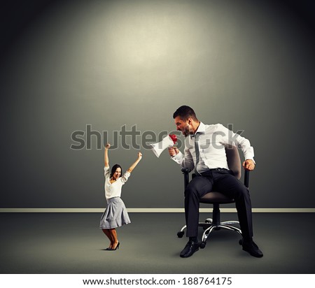 emotional man and happy woman over dark background