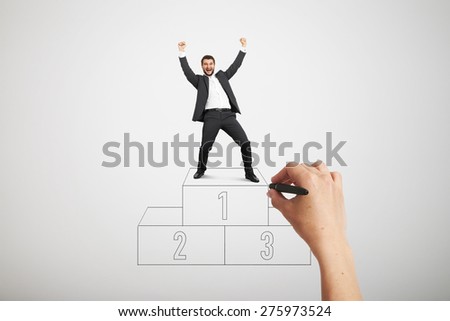 big hand drawing winners podium. happy laughing businessman in formal wear standing on sport winners podium and raising his hands up over light grey background
