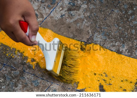 painting the the yellow line on the concrete road