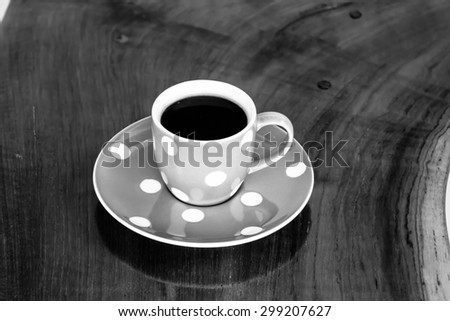 black and white cup of black coffee on wooden table
