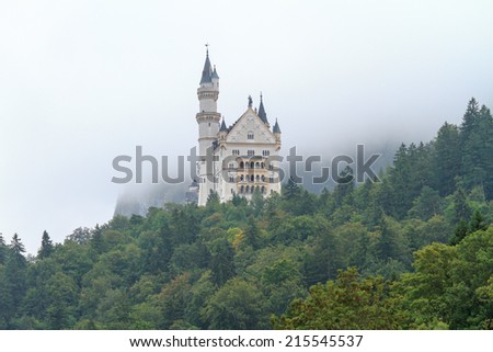 Neuschwanstein, Lovely Autumn Landscape Panorama Picture of the fairy tale castle near Munich in Bavaria, Germany in the morning hours on a foggy day