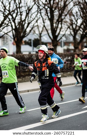 BAMBERG, GERMANY - MARCH 15 2015: Kaiserdomlauf, traditional long distance race event in the City of Bamberg in Bavaria, Germany in March 2015. Firefighter taking part