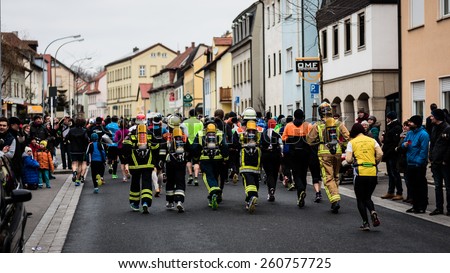 BAMBERG, GERMANY - MARCH 15 2015: Kaiserdomlauf, traditional long distance race event in the City of Bamberg in Bavaria, Germany in March 2015. Firefighters taking part