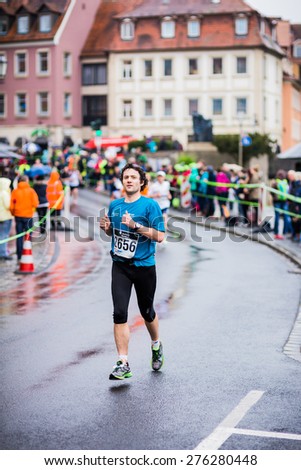 BAMBERG, GERMANY - MAY 03 2015: Weltkulturerbelauf, traditional long distance Marathon race event on a rainy day in the world culture heritage City of Bamberg in Franconia, Germany in May 2015