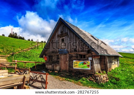FELDBERG, GERMANY - MAY 17 2015: Mountain Hut at Feldberg Mountain in Germany in Spring. Lovely Hills and Forests. Blue cloudy sky. Fantastic Landscape