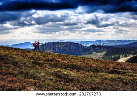 FELDBERG, GERMANY - MAY 17 2015: People hiking at Feldberg Mountain in Germany in Spring. Lovely Hills and Forests. Blue cloudy sky. Fantastic Landscape