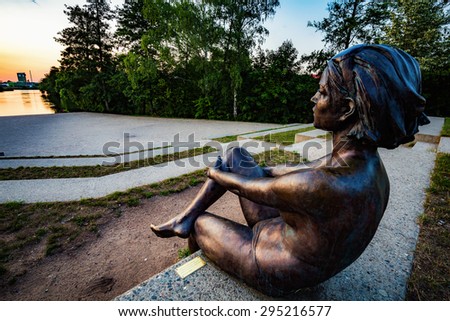 BAMBERG, GERMANY - JULY 09 2015: Bamberg City. Statue of a young woman at the ERBA river island on a warm summer evening