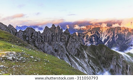 Spectacle of Nature. Fog rolling over the mountains in the Karwendel mountain range in Tyrol, Austria in the high mountains of the Alps on a late summer evening at sunset