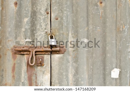 Old zinc door locked with key