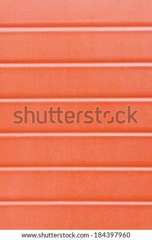 Grungy red plastic wall sheathing cover fragment