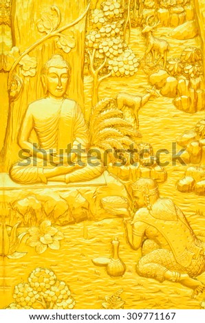 Traditional Thai style art carving of Buddha story on temple door