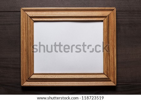 old empty frame on wooden wall