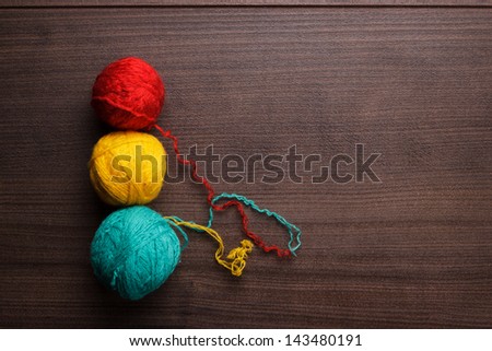 colorful ball of threads on wooden background