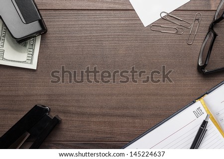 office brown wooden table with pen glasses and notebook background