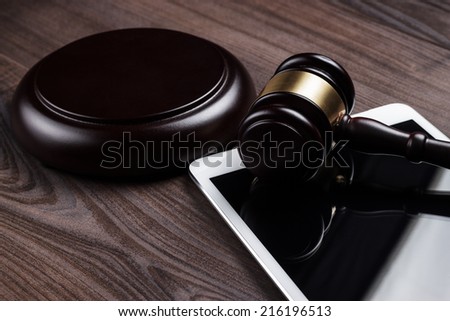 judge gavel and tablet computer on the table