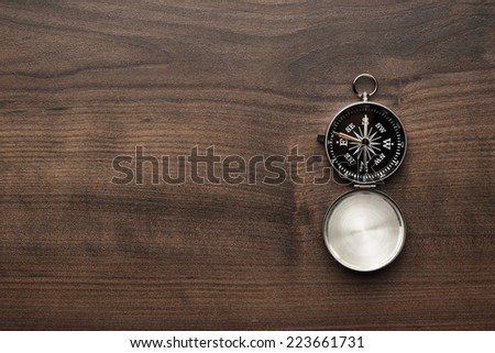 compass on the brown wooden table background
