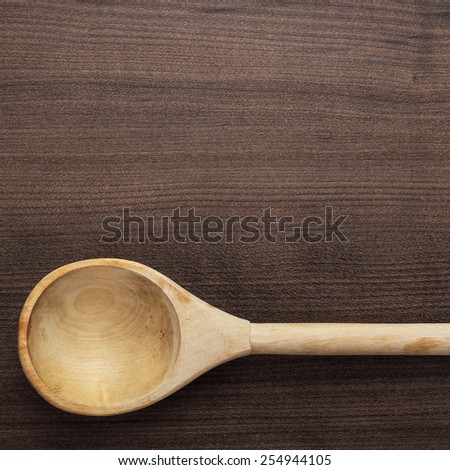 old wooden spoon on the blue table
