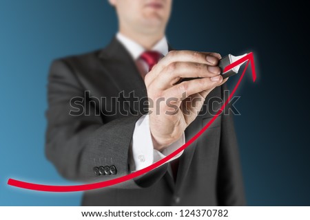 business man on blue background is drawing white empty flow chart regarding computer system process