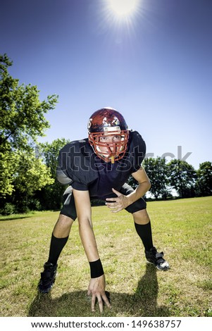 American football player offensive Lineman in three point stance