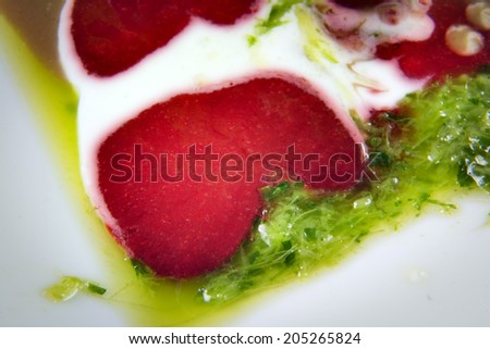 Close-up strawberry olive dressing on a plate with salad