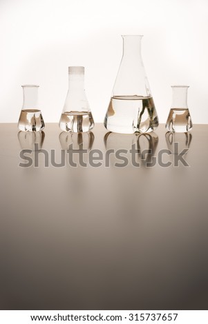 Measuring glasses on a table of a chemical laboratory and free space
