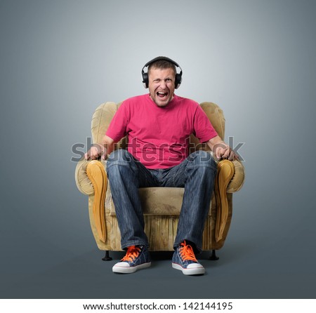 Emotional man listens to music on headphones. Sound concept