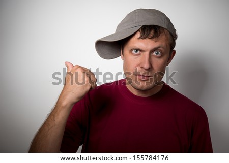 Man in the cap shows hand back