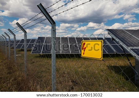 Power plant using renewable solar energy with warning sign: Danger and copy-space