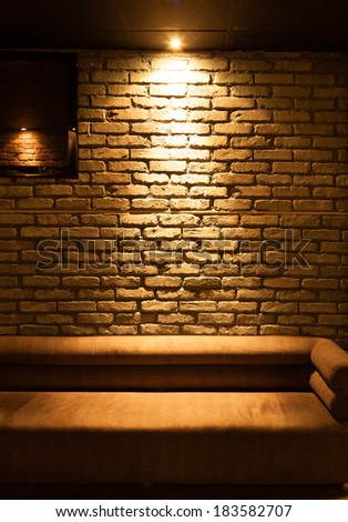 Old type brick wall texture front face and sofa with local lighting