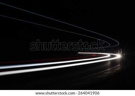 Light tralight trails in tunnel. Art image. Long exposure photo taken in a tunnel.