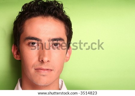 Young mans face on green background