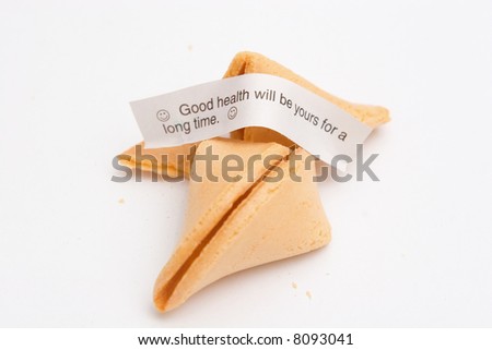 Broken and crumbled fortune cookie, showing a fortune that reads 