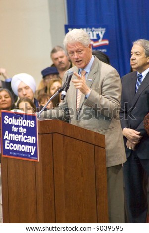 A vertical image of former President Bill Clinton speaking at a rally for Hillary Clinton\'s Campaign.