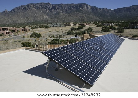 solar panel array against a mountain backdrop