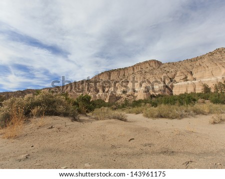 Sweeping landscape horizontal view on partly cloudy day of Tent Rocks National Monument on Cochiti Pueblo in Sandoval County New Mexico, USA