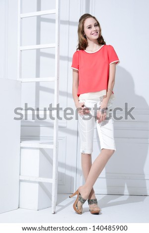 Full body young girl with ladder posing in studio