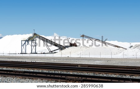 Mountains of salt and equipment for loading.  Great Salt Lake, Utah, United States