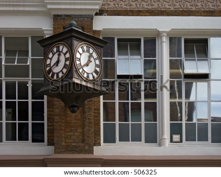 old two faced clock on an old building